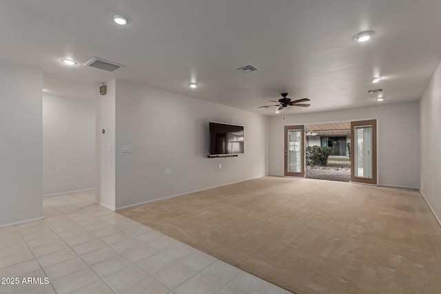 unfurnished living room with light colored carpet, visible vents, and ceiling fan