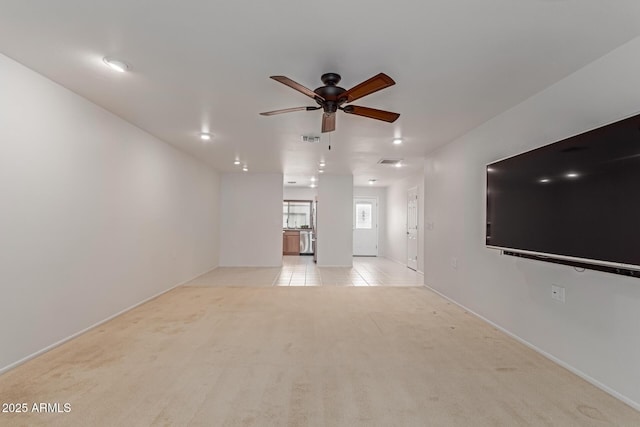 unfurnished living room featuring ceiling fan, visible vents, light carpet, and light tile patterned flooring