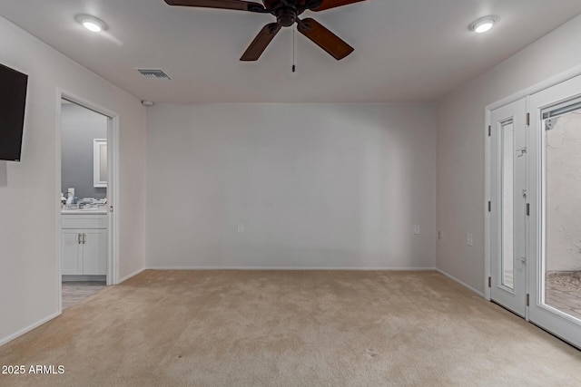 unfurnished bedroom with visible vents, a ceiling fan, access to outside, ensuite bath, and light colored carpet