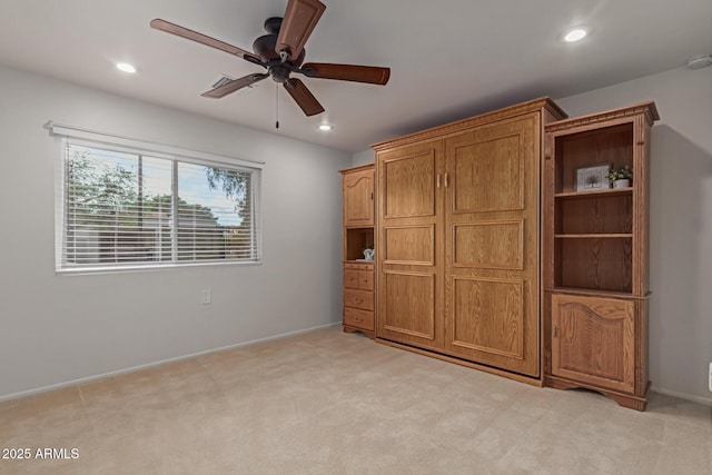 unfurnished bedroom with light carpet, recessed lighting, and baseboards