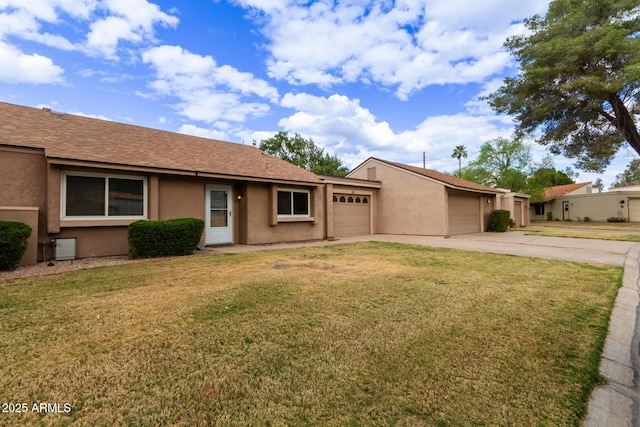 single story home with concrete driveway, an attached garage, a front lawn, and stucco siding