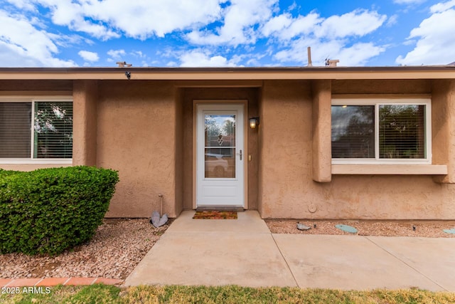 entrance to property with stucco siding