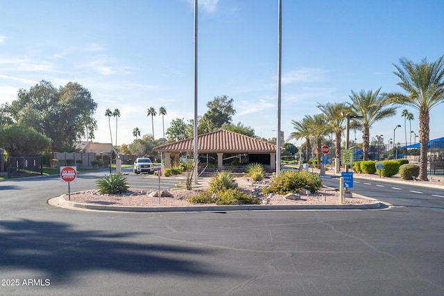 view of road with curbs, traffic signs, and street lighting