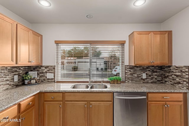 kitchen featuring a sink, decorative backsplash, light stone counters, and dishwasher