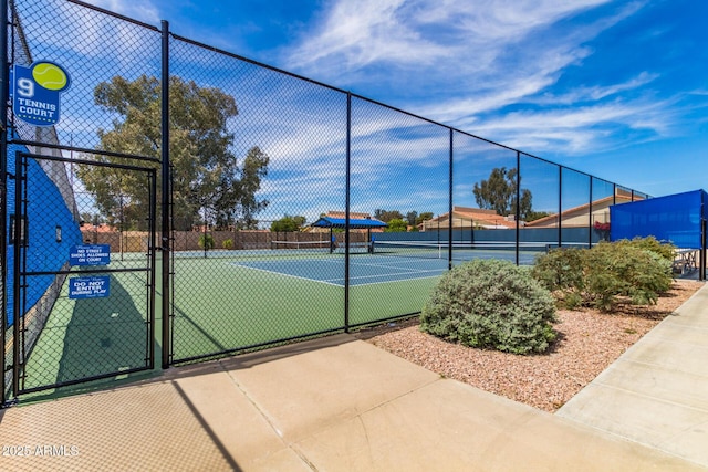 view of sport court featuring a gate and fence