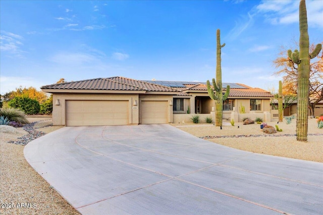 view of front of house featuring a garage and solar panels