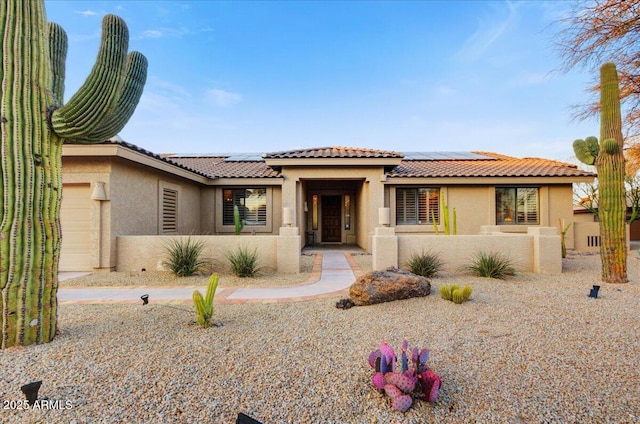 view of front of house with solar panels and a garage