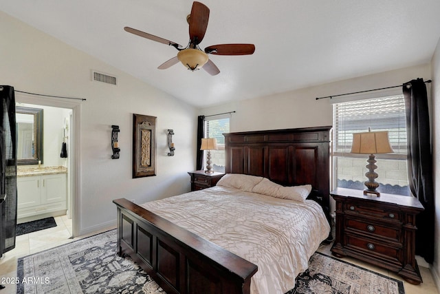 bedroom with connected bathroom, visible vents, vaulted ceiling, and ceiling fan