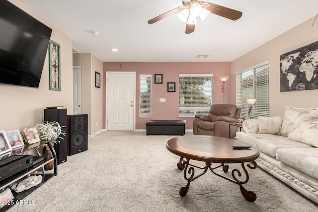 living room featuring carpet and ceiling fan