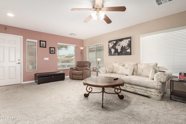 carpeted living room with ceiling fan