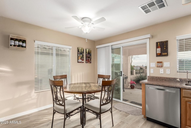 dining room with ceiling fan and light wood-type flooring