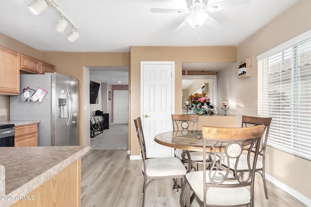 dining space featuring ceiling fan and light hardwood / wood-style floors