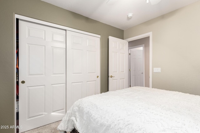 bedroom with carpet, ceiling fan, and a closet