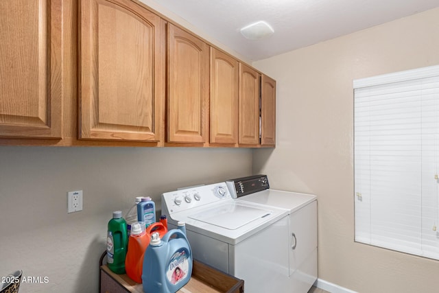 washroom featuring cabinets and separate washer and dryer