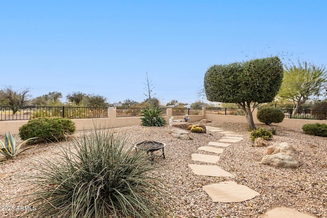 view of yard featuring an outdoor fire pit