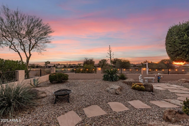 yard at dusk with a fire pit