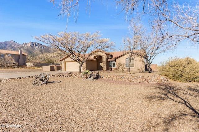 view of front of property with a mountain view and a garage