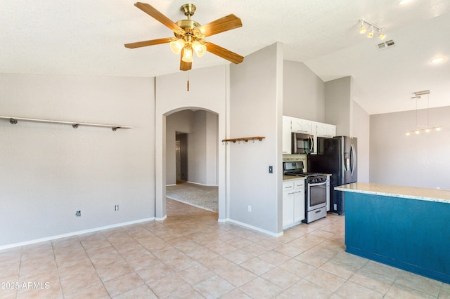 kitchen with white cabinetry, vaulted ceiling, pendant lighting, ceiling fan, and stainless steel appliances