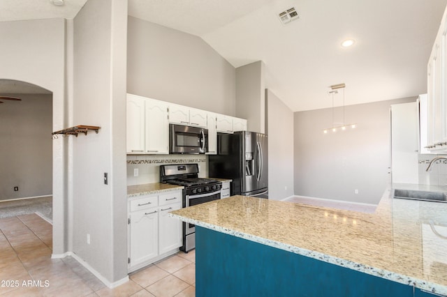 kitchen featuring stainless steel appliances, light stone countertops, and sink