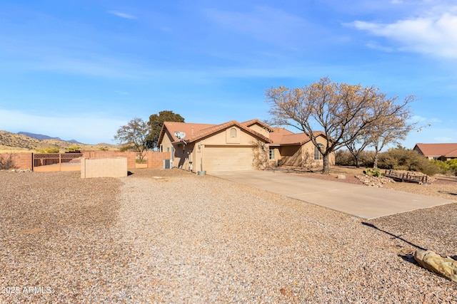 ranch-style house with a mountain view and a garage