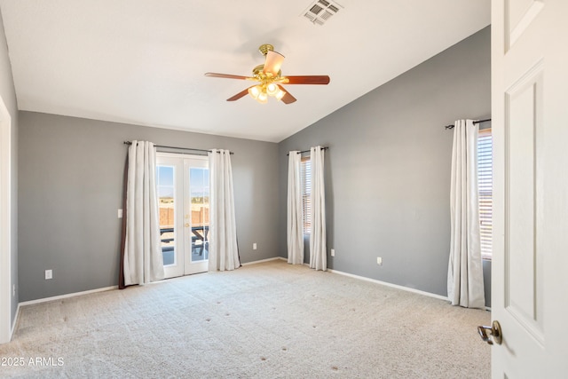 carpeted empty room featuring french doors, ceiling fan, and lofted ceiling