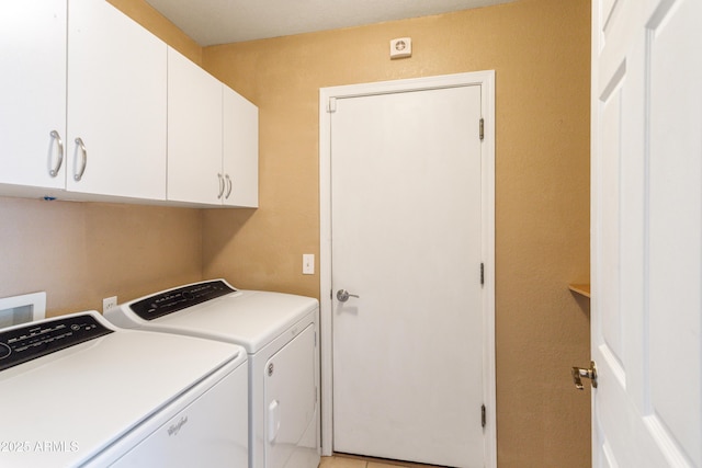 washroom with cabinets and washing machine and clothes dryer