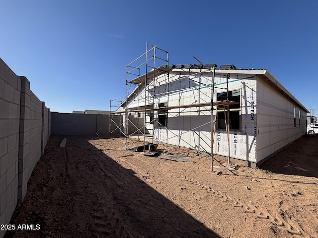 rear view of property featuring a fenced backyard