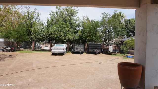 view of vehicle parking featuring fence