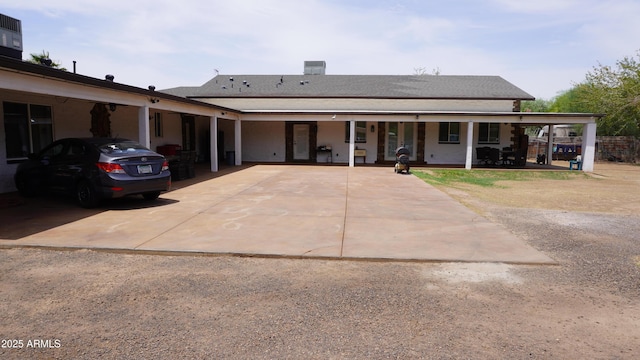 view of front of house featuring an attached carport and driveway