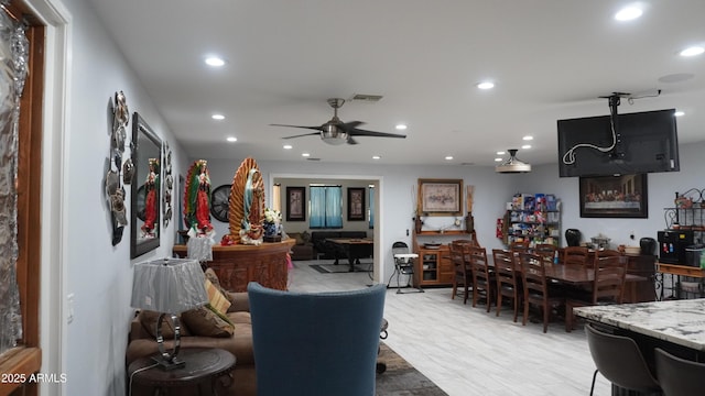 living area featuring a ceiling fan, recessed lighting, and visible vents