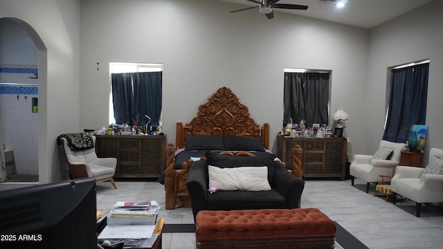 bedroom with visible vents, arched walkways, and ceiling fan