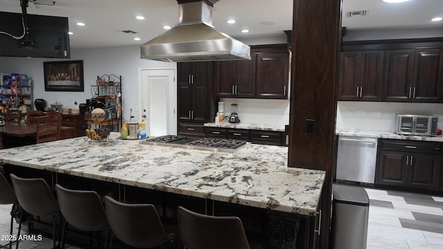 kitchen featuring a breakfast bar area, island exhaust hood, a toaster, visible vents, and appliances with stainless steel finishes