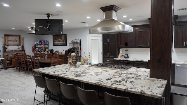 kitchen with visible vents, island range hood, and recessed lighting