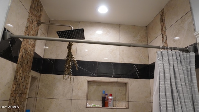 bathroom with tiled shower and radiator heating unit