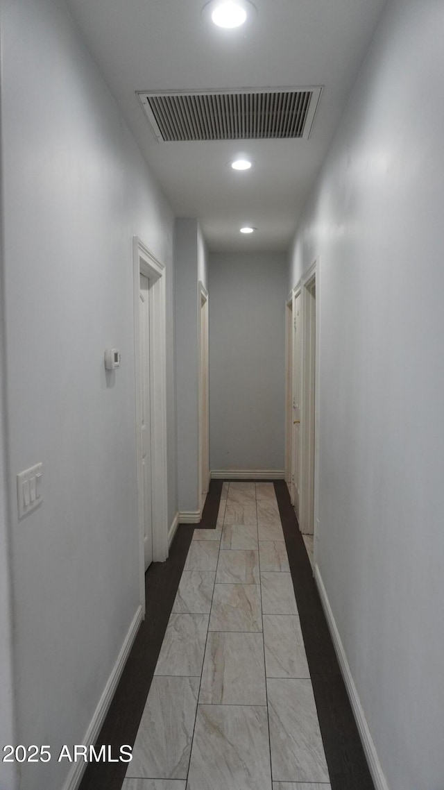 hall featuring marble finish floor, recessed lighting, baseboards, and visible vents