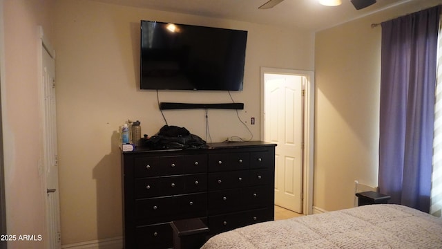 bedroom with baseboards and a ceiling fan