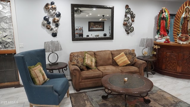 living room featuring marble finish floor and a ceiling fan