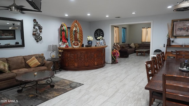 interior space with visible vents and ceiling fan