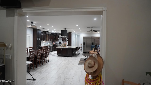 interior space with light countertops, stainless steel fridge, ceiling fan, recessed lighting, and dark brown cabinets