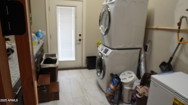 laundry room featuring laundry area and stacked washing maching and dryer