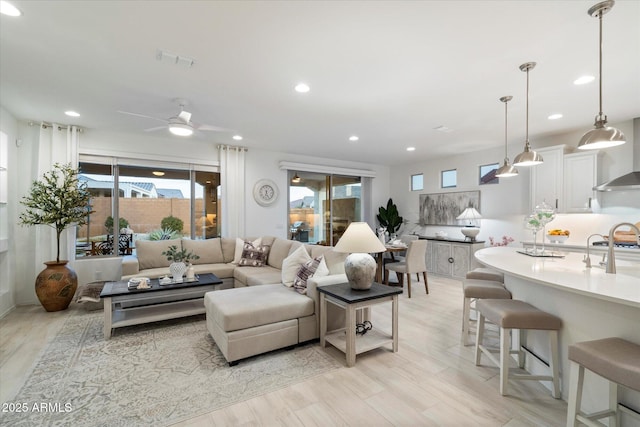 living room with visible vents, recessed lighting, light wood-style floors, and ceiling fan