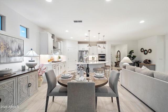 dining room with visible vents, recessed lighting, and light wood-type flooring