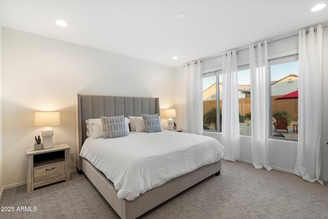 bedroom with recessed lighting, light colored carpet, and baseboards