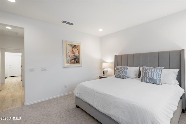 bedroom with light colored carpet, recessed lighting, visible vents, and baseboards