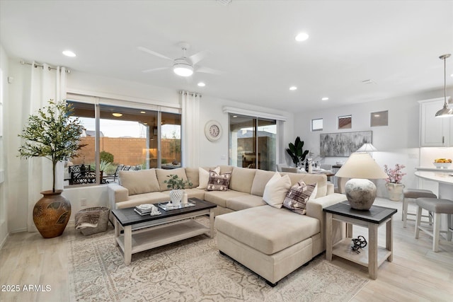 living area featuring recessed lighting, light wood finished floors, and ceiling fan