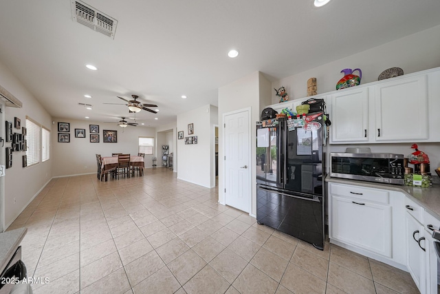 11563 W Jefferson St, Avondale, AZ 85323 - kitchen with freestanding refrigerator, stainless steel microwave, plenty of natural light, light tile patterned flooring, and recessed lighting