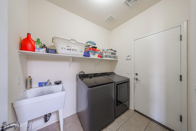 11563 W Jefferson St, Avondale, AZ 85323 - laundry room featuring washing machine and dryer and light tile patterned floors