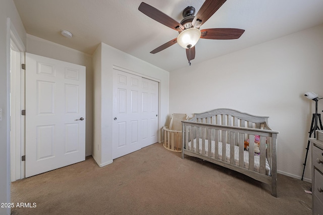 11563 W Jefferson St, Avondale, AZ 85323 - carpeted bedroom featuring a closet, ceiling fan, baseboards, and a crib
