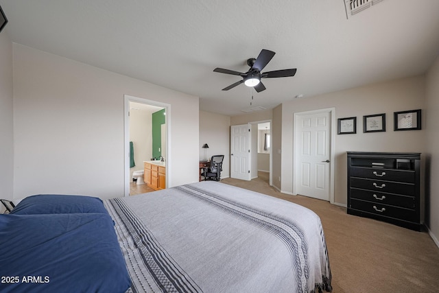 11563 W Jefferson St, Avondale, AZ 85323 - bedroom with light carpet, baseboards, a ceiling fan, and connected bathroom