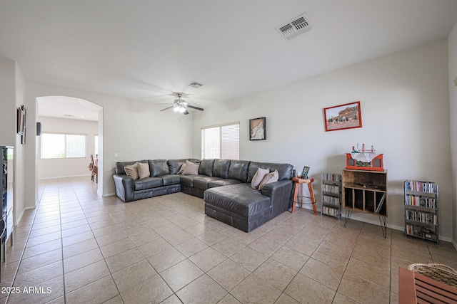 11563 W Jefferson St, Avondale, AZ 85323 - living area featuring arched walkways, light tile patterned flooring, ceiling fan, and baseboards